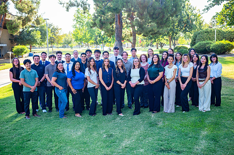 Group shot of Craig Business Scholars student group on a green lawn on the Fresno State campus